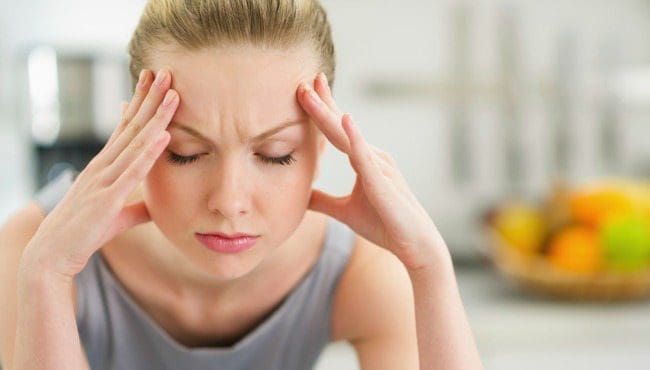 woman at home pounding headache