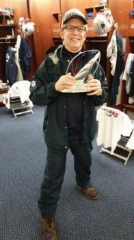 blog picture of chiropractor with award in locker room