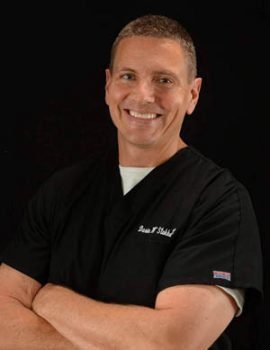 blog picture of chiropractor smiling arms crossed