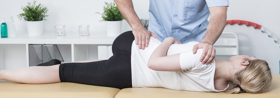 blog picture of young woman getting hip adjusted by chiropractor