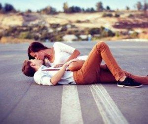 blog picture of man and woman lying down on the road making out