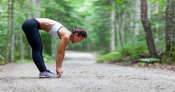 stretching on running trail