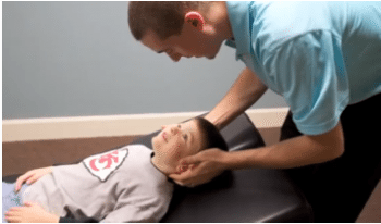blog picture of chiropractor about to work on young child