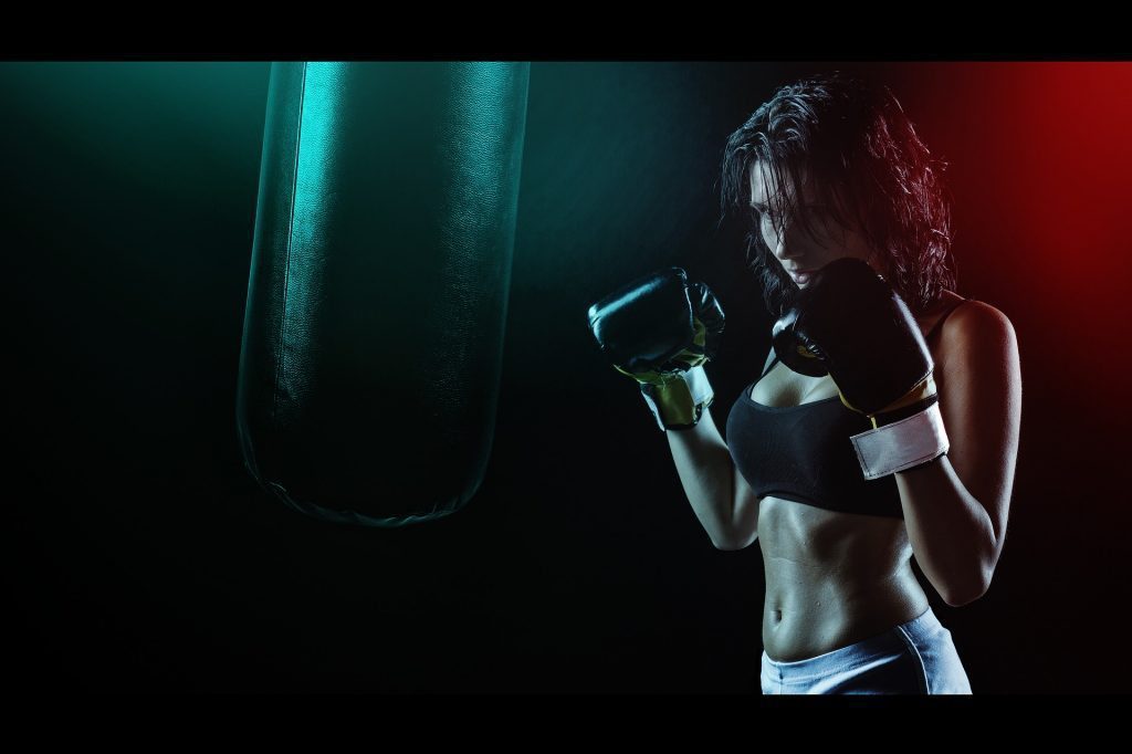 blog picture of female boxer practicing with punching bag