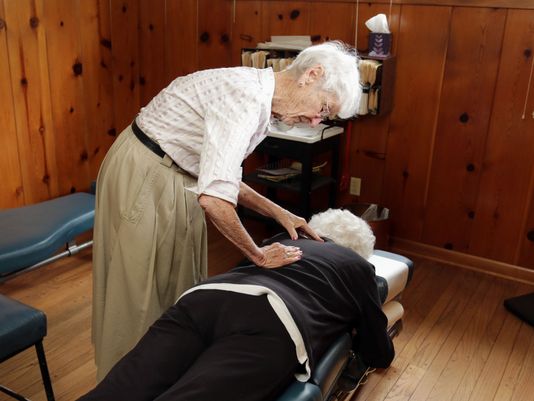 blog picture of oldest living practicing chiropractor working on a patient