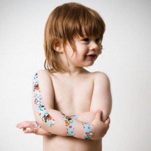 blog picture of little boy with kinesiology tape