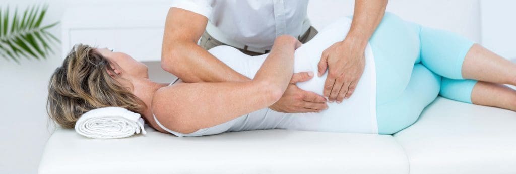 doctor massaging his patient back in medical office