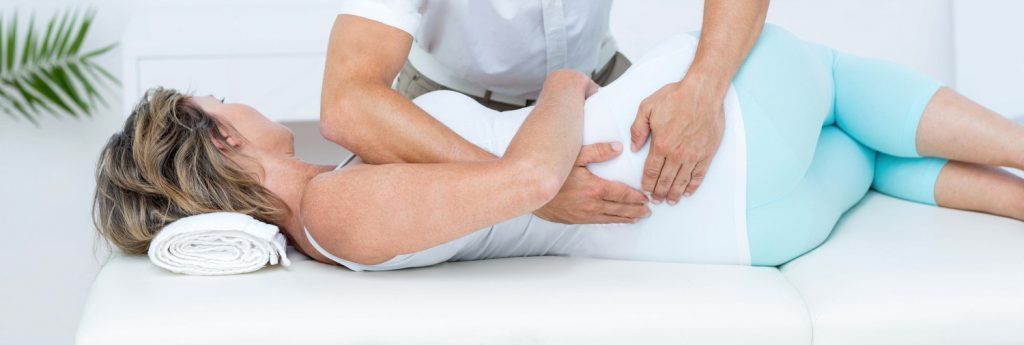 stock photo doctor massaging his patient back in medical office