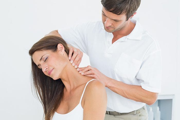chiropractor works on woman's neck