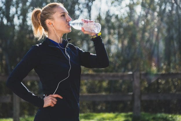 sports woman drinking water